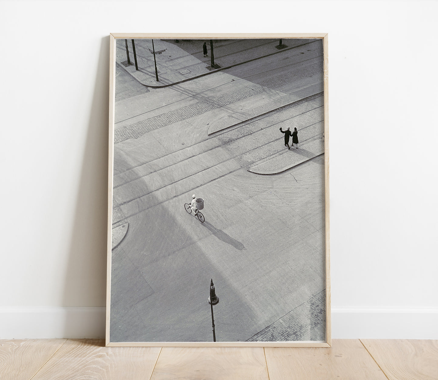 Framed black and white photograph of a city street with people on a sidewalk.