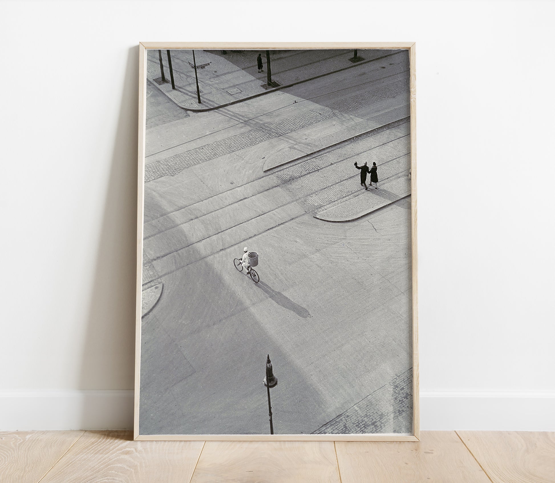 Framed black and white photograph of a city street with people on a sidewalk.