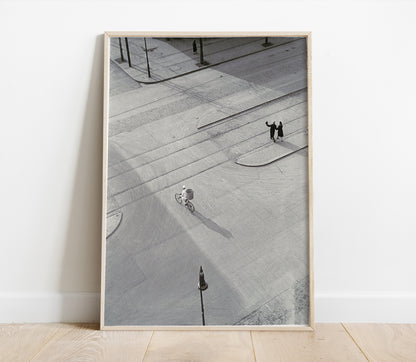 Framed black and white photograph of a city street with people on a sidewalk.