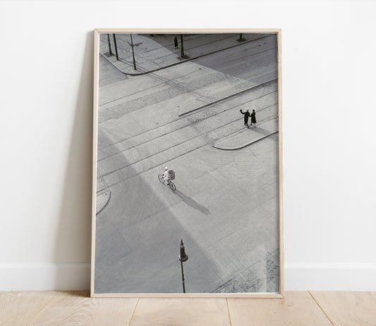 Framed black and white photograph of a city street with people on a sidewalk.